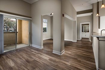 Living room with private balcony at The Madison at Town Center Apartments in Santa Clarita CA